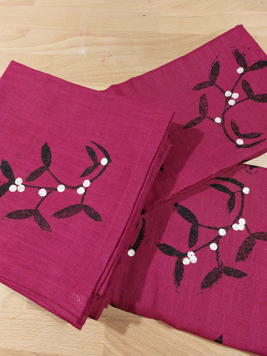 mistletoe napkins on dark red