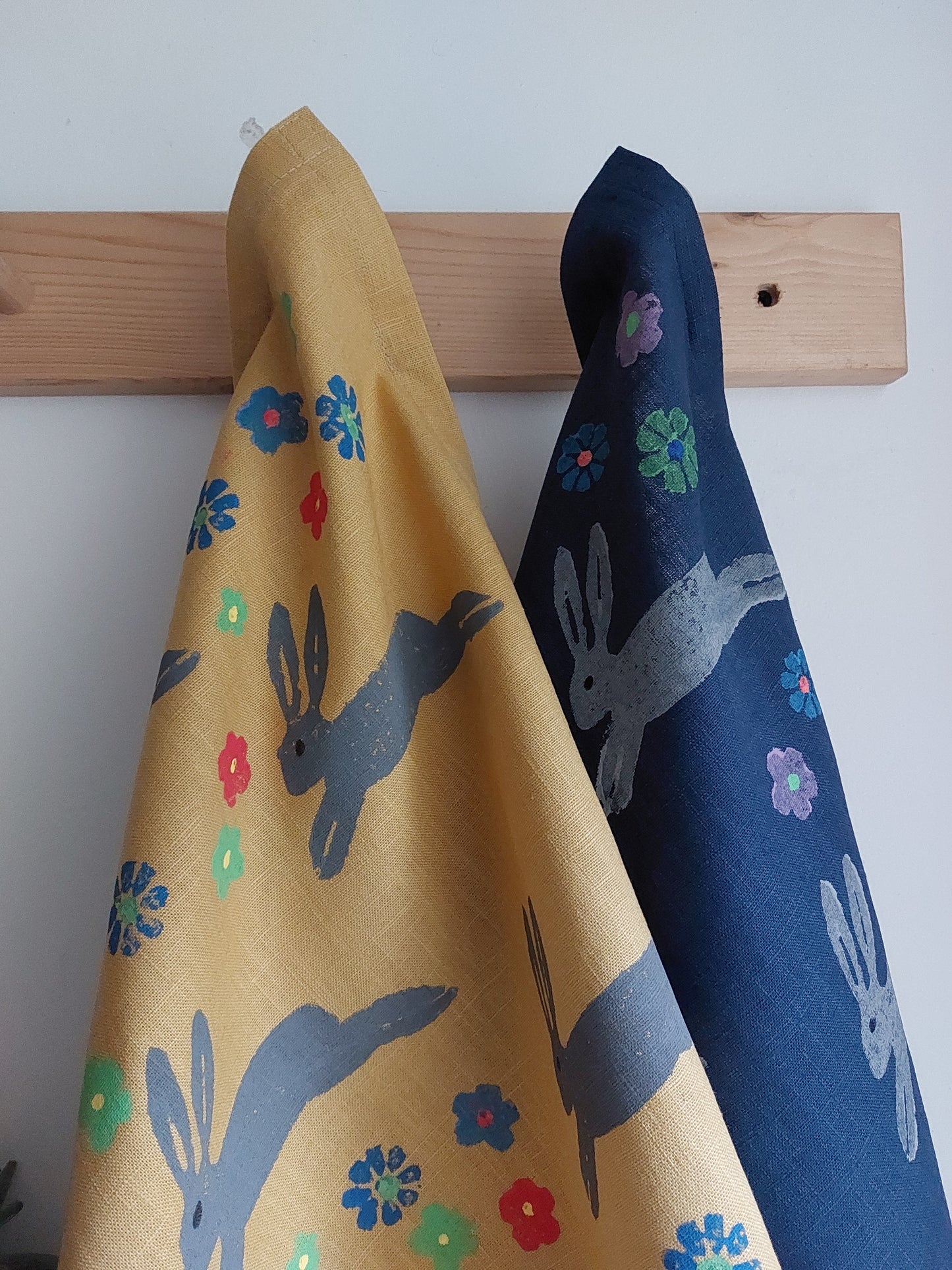 leaping spring hare tea towel mustard