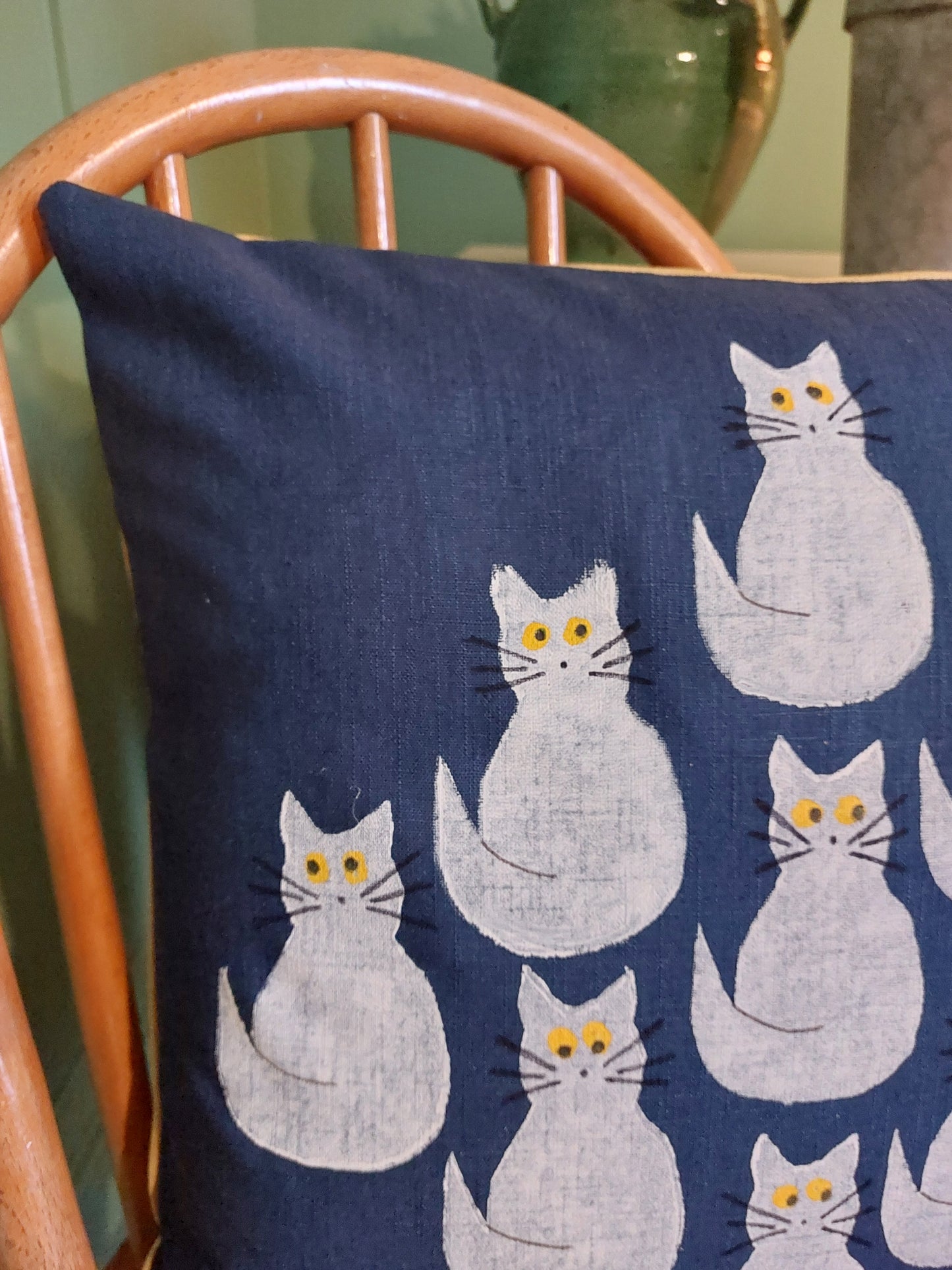 white cats on navy cushion