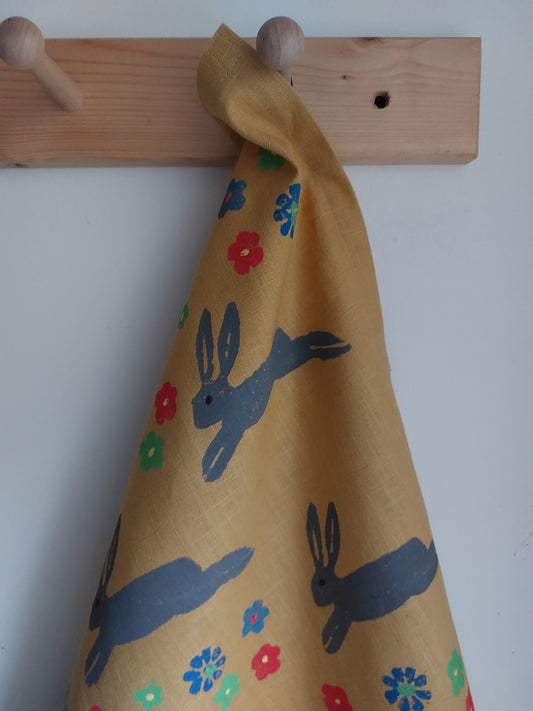 leaping spring hare tea towel mustard
