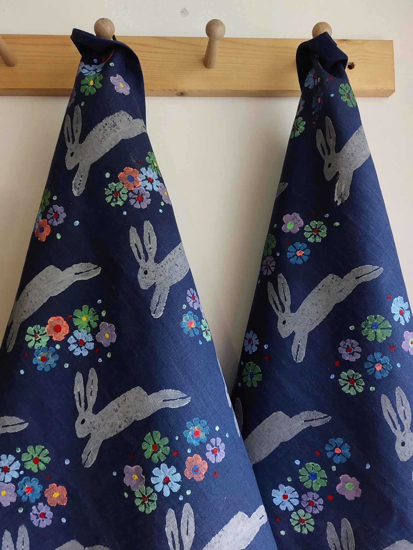 leaping spring hare tea towel navy